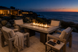 Alameda 60" Fire Table – Weathered Grey Woodgrain, Malibu terrace at dusk.